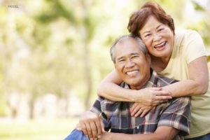 Older Asian Couple Smiling At The Camera
