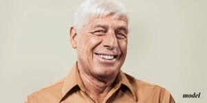 Older Male Smiling With Dental Implants